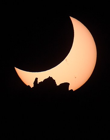Eclipsed Sun setting behind The Shiprock